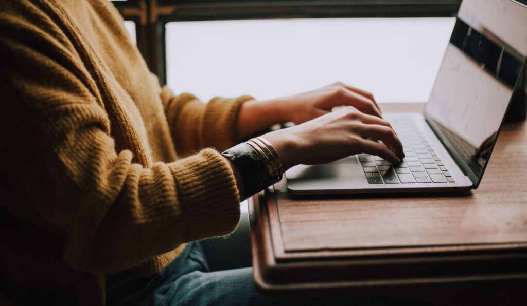 a person typing on a laptop