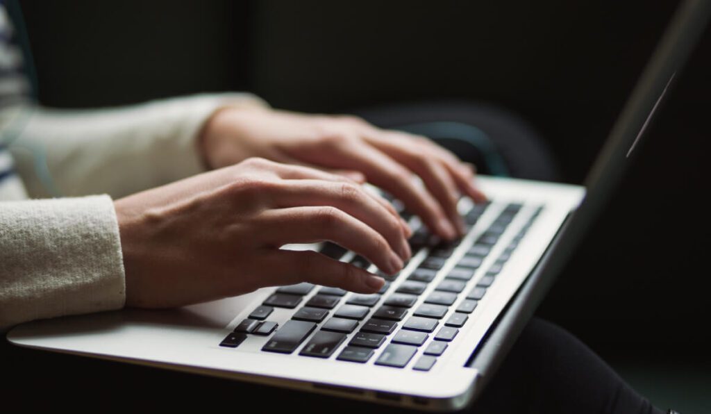 a person typing on a laptop